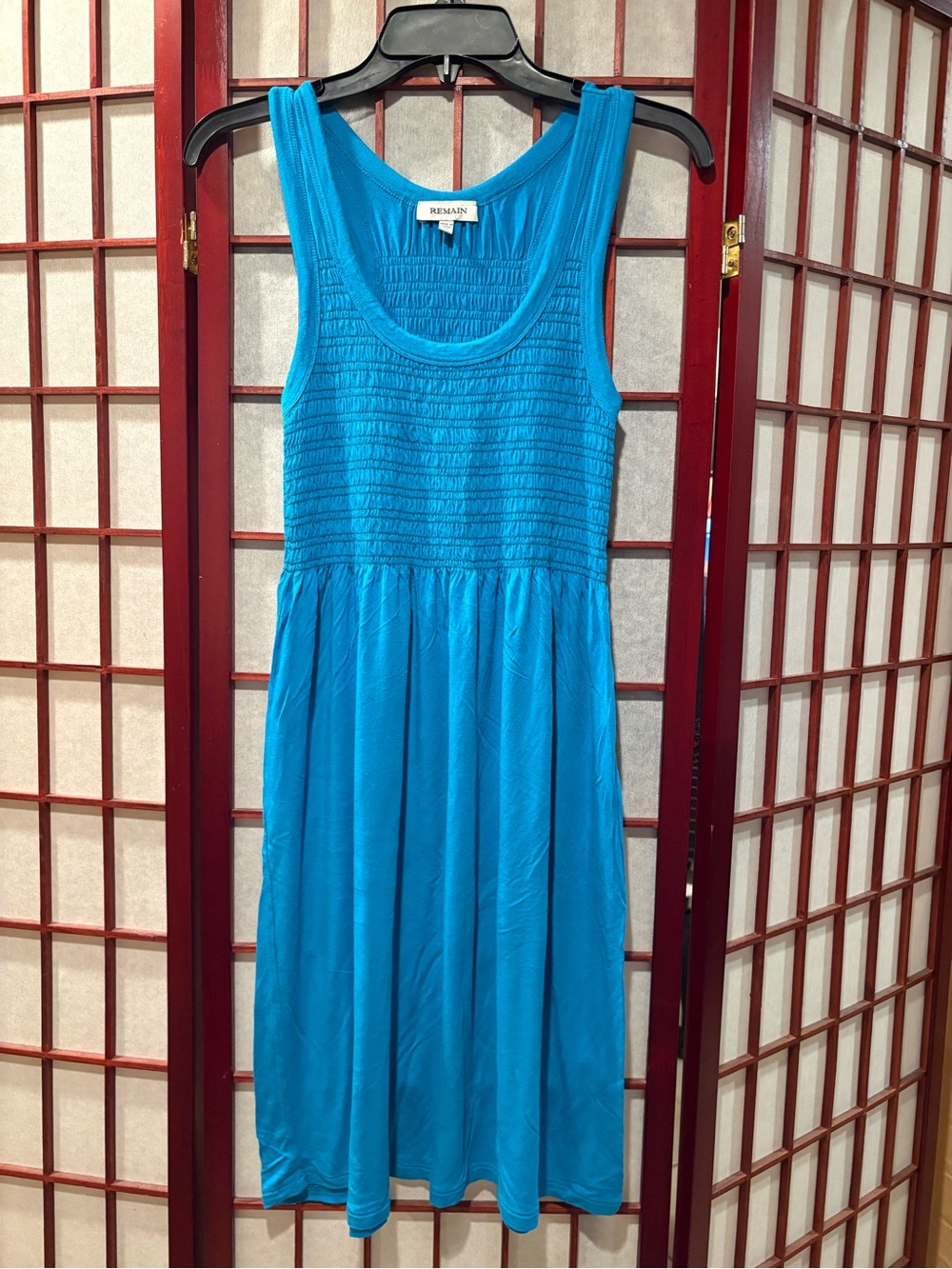REMAIN Sleeveless Smocked Mini Dress in Turquoise Blue